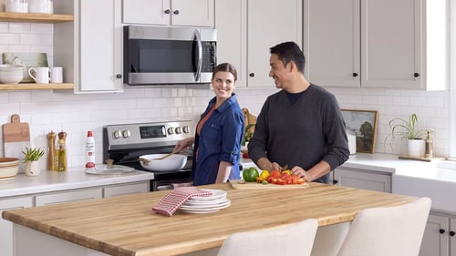 A Couple in a kitchen cooking