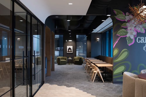 Hallway with several small rooms for meetings leading to the breakroom