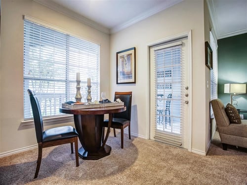 A dining room with a table and chairs at Remington at Memorial Apartments, Tulsa, Oklahoma