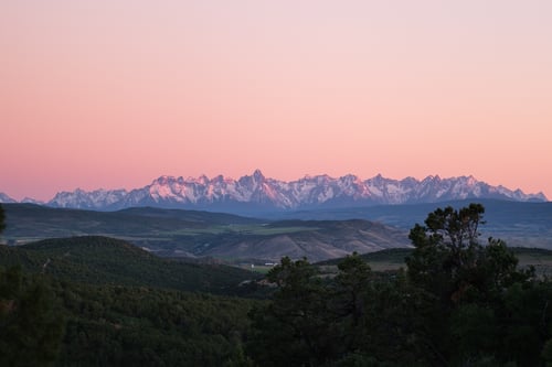 Sunset pink sky above San Juan mountain range near Montrose CO