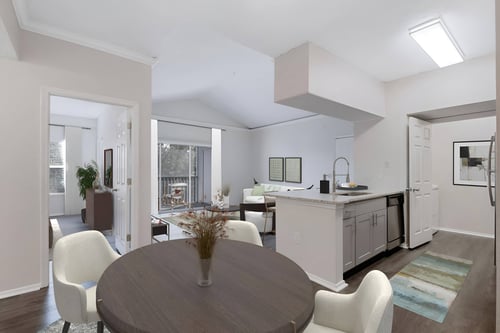 a living room with a dining room table and a kitchen