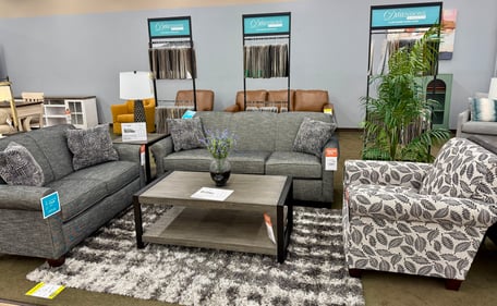 Dimensions by England custom living room set featuring gray sofa, loveseat, and patterned accent chair on display at Slumberland Furniture Burlington. Explore customizable sofas and chairs in Burlington, Iowa for every style and budget.