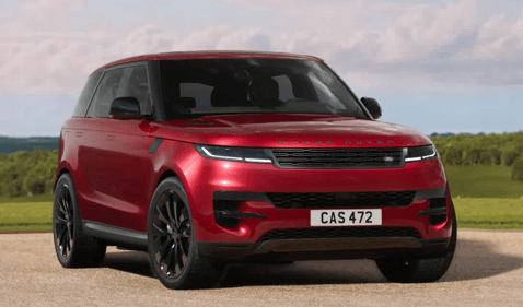 Front view of a red Range Rover Sport parked on a country road.