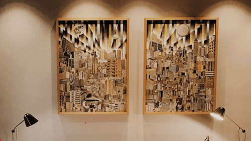 Two large piece of art hanging on a wall