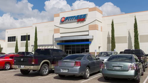Cars parked along entrance of 24 Fitness at Orange Grove Shopping Center